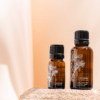 Close up shot of frankincense essential oils in 2 small different sizes of bottles